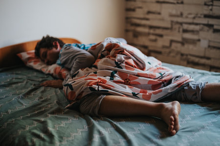 Man sleeping peacefully in cozy bedroom with colorful bedding