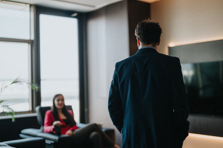 Professional colleagues engaged in a conversation in a modern office settingの写真素材