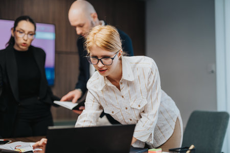 Team Collaboration in an Office Setting with Focused Business Professionalsの写真素材