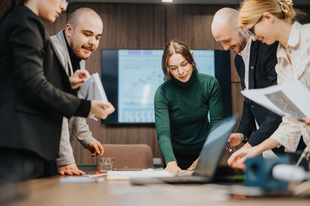 Group of coworkers collaborating on a business project in an office setting
