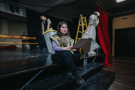 Young Actors Rehearsing a Dramatic Scene on a Theatre Stageの写真素材