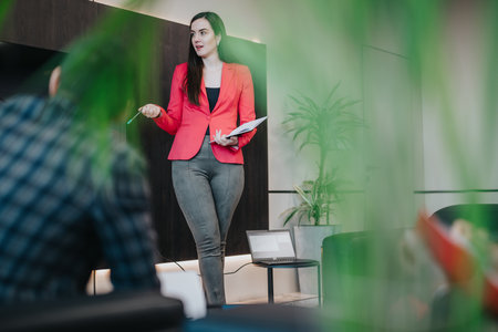 Businesswoman Leading a Presentation with a Laptop Displayed On a Table