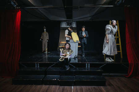 Actors performing a theatrical scene on stage with vibrant costumesの写真素材