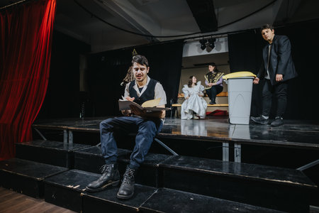 Young actors performing a dramatic scene on stage in a theaterの写真素材