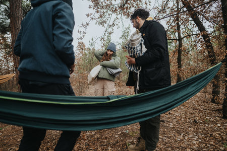 Young friends enjoying time together outdoors in an autumn forest settingの写真素材