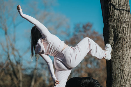A young woman practicing outdoor fitness and yoga in a natural park environment wearing active wear