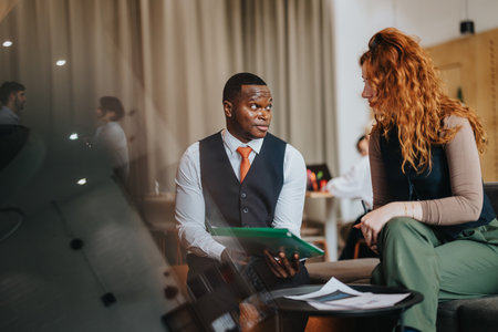 Two people collaborating in a modern business environmentの写真素材