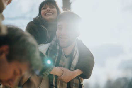 Group of Friends Smiling Outdoors During a Bright Autumn Dayの写真素材