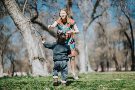 Child and adult playing outdoors during spring in a park, fostering happiness and bonding in nature