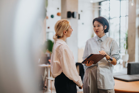 Business people discussing work in a modern co working spaceの写真素材