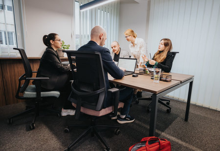 Group of business colleagues collaborating in a modern office environmentの写真素材