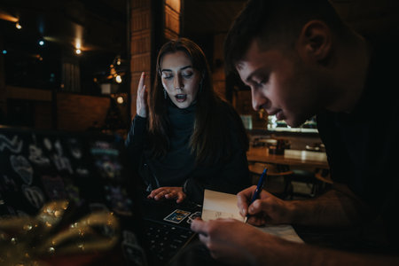 Collaborative workspace scene with two focused individuals engrossed in taskの写真素材