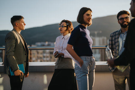 Diverse business team brainstorming on rooftop at sunsetの写真素材