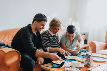 A senior woman enjoying quality time cooking with her family at homeの写真素材