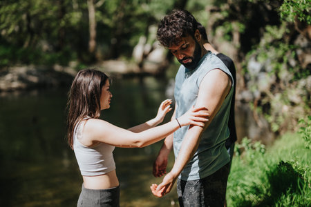 Couple enjoying a peaceful outdoor escape near a picturesque riversideの写真素材