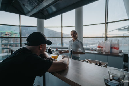 Business meeting at a rooftop bar during sunset in the cityの写真素材