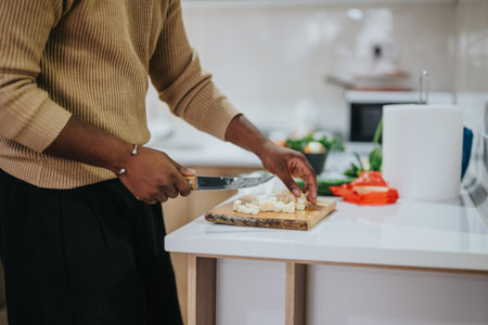 Person preparing vegetables on a kitchen counter for a mealの写真素材