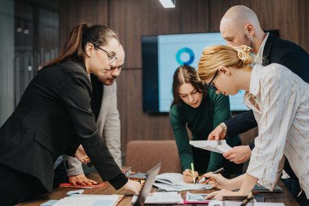 Group of coworkers collaborating on projects in a modern officeの写真素材
