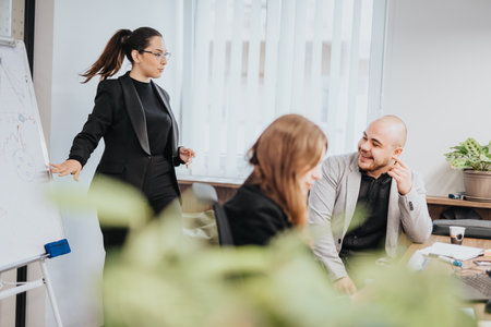 Business people engaged in a collaborative meeting in a modern officeの写真素材