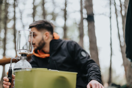 Man Outdoors Enjoying Warm Moments With Cypress Brewing Equipment During Winterの写真素材
