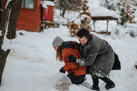 Friends playing in the snow during a fun winter day outdoorsの写真素材