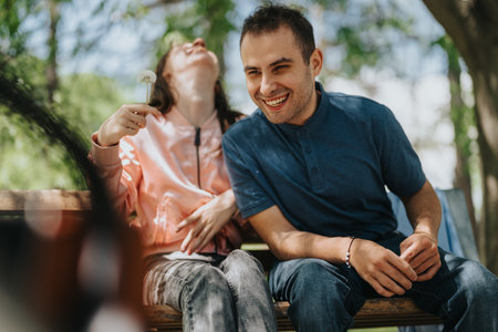 A cheerful couple enjoying time together outdoors on a sunny day in a natural park setting