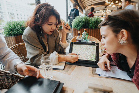 Business people having an outdoor meeting at a cafeの写真素材