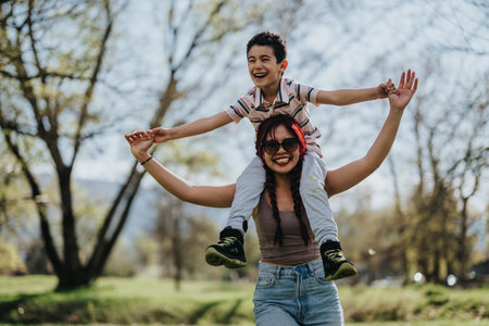 Mother and child enjoying a sunny day together at the parkの写真素材