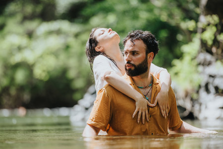 Man and woman in nature, sharing a peaceful moment by the water.の写真素材