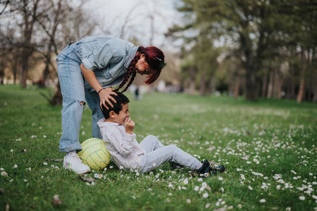 Mother and son enjoying quality time in a park on a sunny dayの写真素材