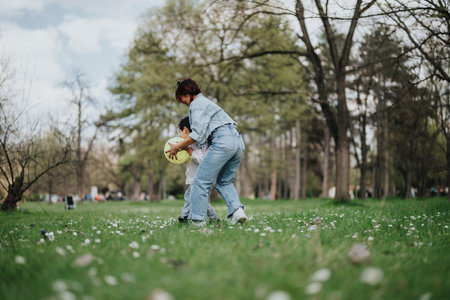 Mother and Child Playing Together Outdoors in a Sunny Parkの写真素材