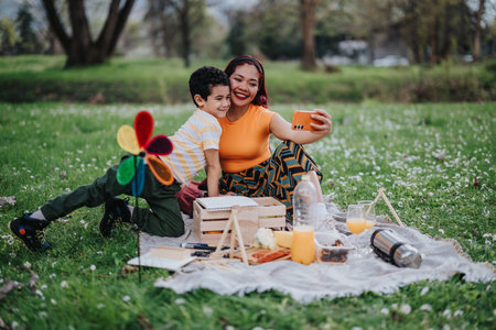 Mother and young son enjoying a picnic in a lush park settingの写真素材