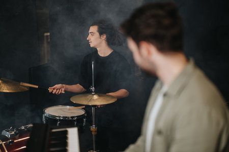 Musicians rehearsing together in a band studio with instruments and musical equipment