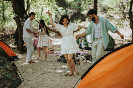 Group of friends camping and enjoying a fun activity outdoors in the wildernessの写真素材