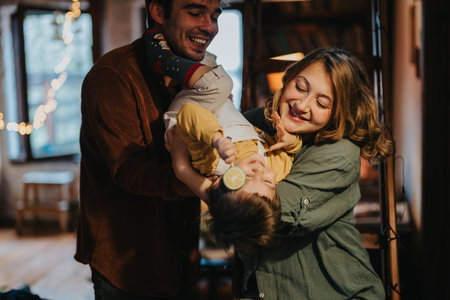 Happy Family Bonding Time at Home in a Cozy Settingの写真素材