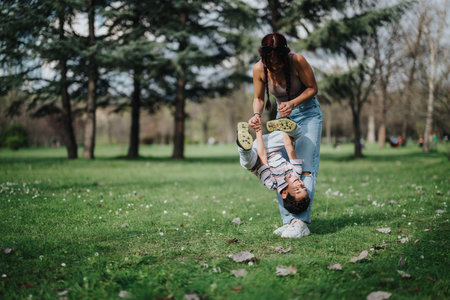 Mother and son playing joyfully in a scenic park settingの写真素材