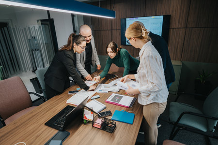 Team of professionals collaborating during a business meeting in a modern officeの写真素材
