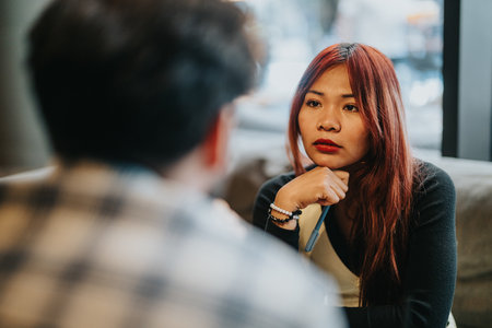 Two business associates having a focused conversation in a casual modern setting