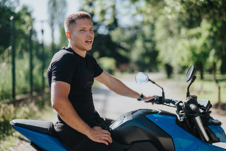 Man Relaxing on a Blue Motorcycle in a Sunny Outdoor Park Setting