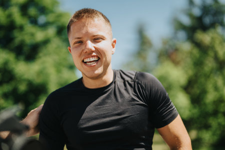 Smiling athlete enjoying a sunny day in a green park settingの写真素材