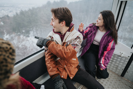 Friends enjoying a scenic winter view while riding in a cable car.