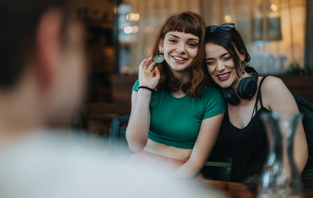 Two young women enjoying a casual gathering with friends