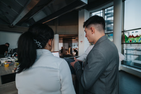 A group of professionals engage in a discussion during a business meeting in a contemporary office...