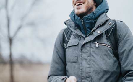 A person dressed warmly smiling outdoors on a winter day
