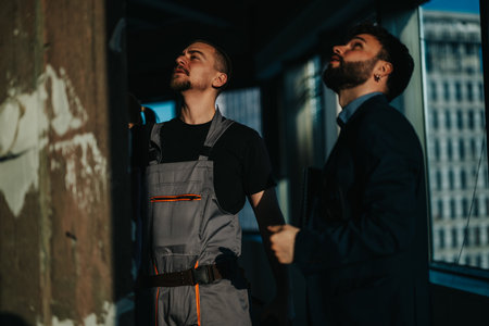 Two professionals examining interior construction project for design insights and structural considerationsの写真素材