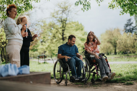 Group of people enjoying a cheerful outdoor gathering in a park setting