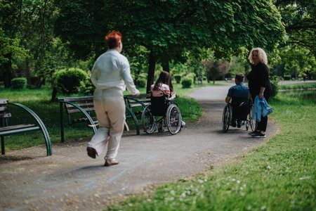 A group of friends enjoying outdoor activities in a lush green parkの写真素材