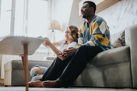 Couple relaxing at home while engaged in a fun video game session together