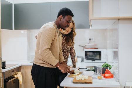 Diverse couple preparing a meal together in their modern kitchen