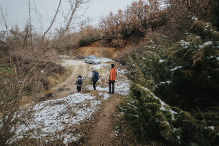 Group hiking through a scenic snowy forested trail in winter season